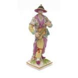 An early 19th century hand-decorated porcelain figure model (probably Berlin) of a Chinese man
