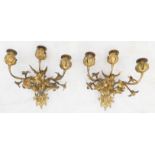 A pair of late 19th to early 20th century three-light gilt-metal wall appliques (for candles):