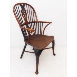A late 18th century yew wood Windsor chair: pierced splat and yew wood bow above an elm saddle-
