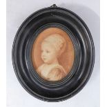 A 19th century oval, ebonised-framed and glazed sepia print of a young child in 17th century
