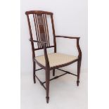 An Edwardian mahogany and boxwood strung open armchair: arched concave top rail above vertical