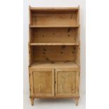An early 19th century Regency period pine waterfall-style bookcase: four shelves above two