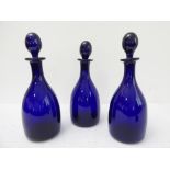 Three Bristol blue glass decanters of mallet form (27 cm high)
