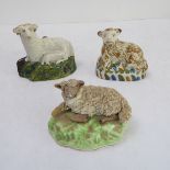 Two 19th century models of recumbent sheep, together with one other later similar porcelain model (