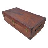A fine patinated brown leather travelling trunk: two side carrying handles and one end with