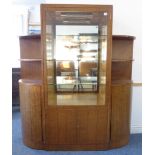 An Art Deco style and period walnut display case: the single central outset mirror-backed glazed