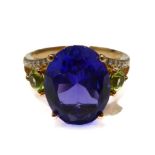 A fine yellow gold (marked '750 18K') dress ring centrally set with a brilliant-cut oval tanzanite