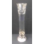 A tall silver-plate-mounted clear-glass vase: slightly tapering cylindrical form, star and