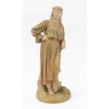 A circa 1892 Royal Worcester blush-ivory figure model: a Romanian peasant standing in front of a