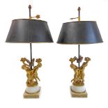 A pair of fine 19th century ormolu table lamps: each modelled as two cherubic-style figures with