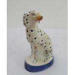 A 19th century seated Staffordshire dalmatian (18 cm high)