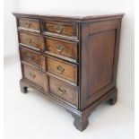 An early 18th century oak chest: banded moulded top above two half-width and three full-width