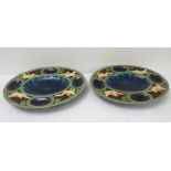 A pair of oval majolica oyster dishes: the four oval oyster reserves to the border interspersed with
