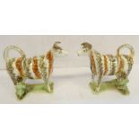 A pair of early 19th century English pearlware milkmaid cow creamers: stripped brown and umber