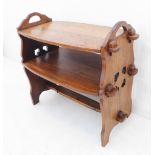 A good and unusual early 20th century two-tier barrel-shaped oak table in high Liberty Arts & Crafts