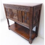 A good mid 17th century carved oak livery cupboard of good colour: the front and side friezes with