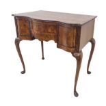 An early 20th century serpentine-fronted figured walnut lowboy in 18th century Dutch style: