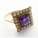 An Edwardian amethyst and seed pearl ring, the central cushion-shaped mixed-cut amethyst to the
