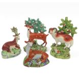 Four early 19th century Staffordshire bocage figures: a ram and young stag, a recumbent stag and a