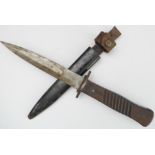 A WWI Imperial German Army fighting knife and scabbard: 15 cm blade and ribbed wooden grip; the