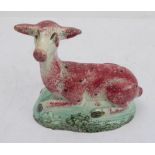 A late 18th to early 19th century Staffordshire pearlware model of a recumbent deer (14 x 7.4 x 14