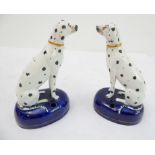 A pair of 19th century Staffordshire inkwells modelled as seated Dalmatians (14.5 cm)