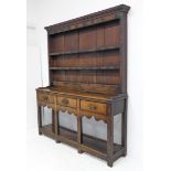 An 18th century oak dresser of good colour and pleasing small proportions: the shelved