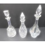 Three cut-glass decanters: baluster form with spire stopper (engraved and dated) (34 cm); lozenge-