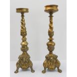 A pair of similar and matched heavy brass pricket sticks: twist-style supports above acanthus bulbs;