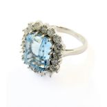 An aquamarine and diamond-set cluster ring, the rectangular cut-cornered step-cut aquamarine claw-