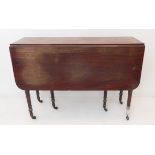 An early 19th century drop-leaf mahogany dining table; the reeded edged top above gateleg action and