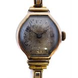 A lady's Art Deco period yellow gold cased wristwatch: the degraded dial with Roman numerals, gold-