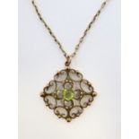 An Edwardian yellow-gold pendant (marked 9CT): centrally set with a hand-cut peridot surrounded by