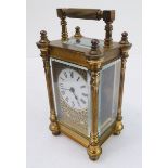 An early 20th century gilt-metal and glass-sided carriage timepiece: white enamel dial with Roman