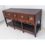 An 18th century oak dresser base of pleasing proportions and colour: moulded top above three small