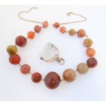 A hardstone graduated spherical bead necklace, the red, brown and green agate spheres (2.4cm-1.1cm