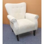A cream upholstered buttonback armchair raised on square tapering ebonised front legs. (Approx. 80
