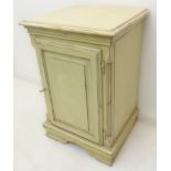 A painted bedside-style cabinet with single fielded panel door enclosing shelf (52 x 47 x 77.5 cm