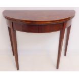 A George III period demi-lune mahogany and boxwood-strung fold-over top card table raised on