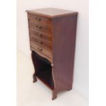 An early 20th century stained wood Edwardian music cupboard; the five full-width drawers with drop