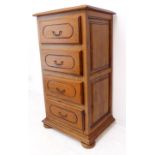 A modern cherrywood vertical bank of four drawers raised on squat bun feet (67 x 51 x 124.5 cm) (
