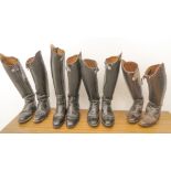 Four pairs of dressage boots (three black, one brown)