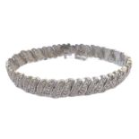 A white-metal bracelet (marked) set with a multitude of small diamonds (20 cm). (Approx. 17.5g)