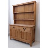 A 19th century pine dresser: two half-width drawers with iron swan-neck handles and two panelled