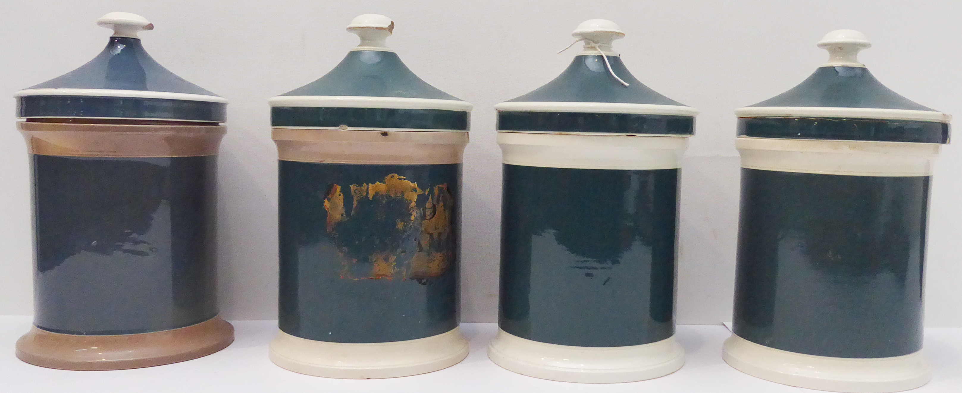Four Victorian pottery drug jars with lids (28 cm high including lids)