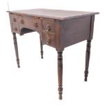 An early 20th century oak side table; the overhanging moulded top above an arrangement of five