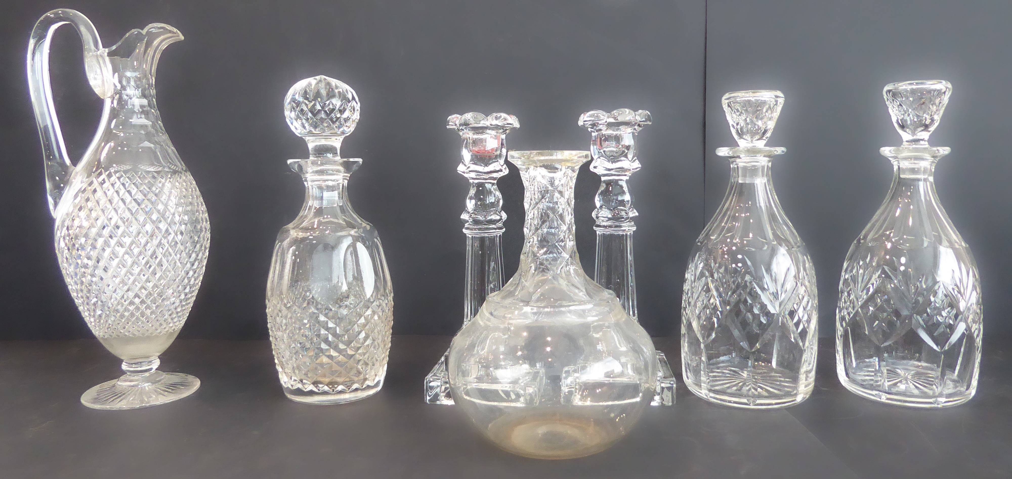 Five quality hand-cut decanters, together with a 19th century style hobnail cut claret jug and a