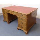 A large reproduction walnut desk: the red Rexine-type inset top above canted corners and an