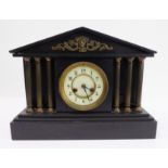 A large late 19th century black slate and metal-mounted eight-day mantle clock in Classical