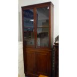 A 19th century mahogany bookcase: the cornice above two glazed doors including shelves, the base